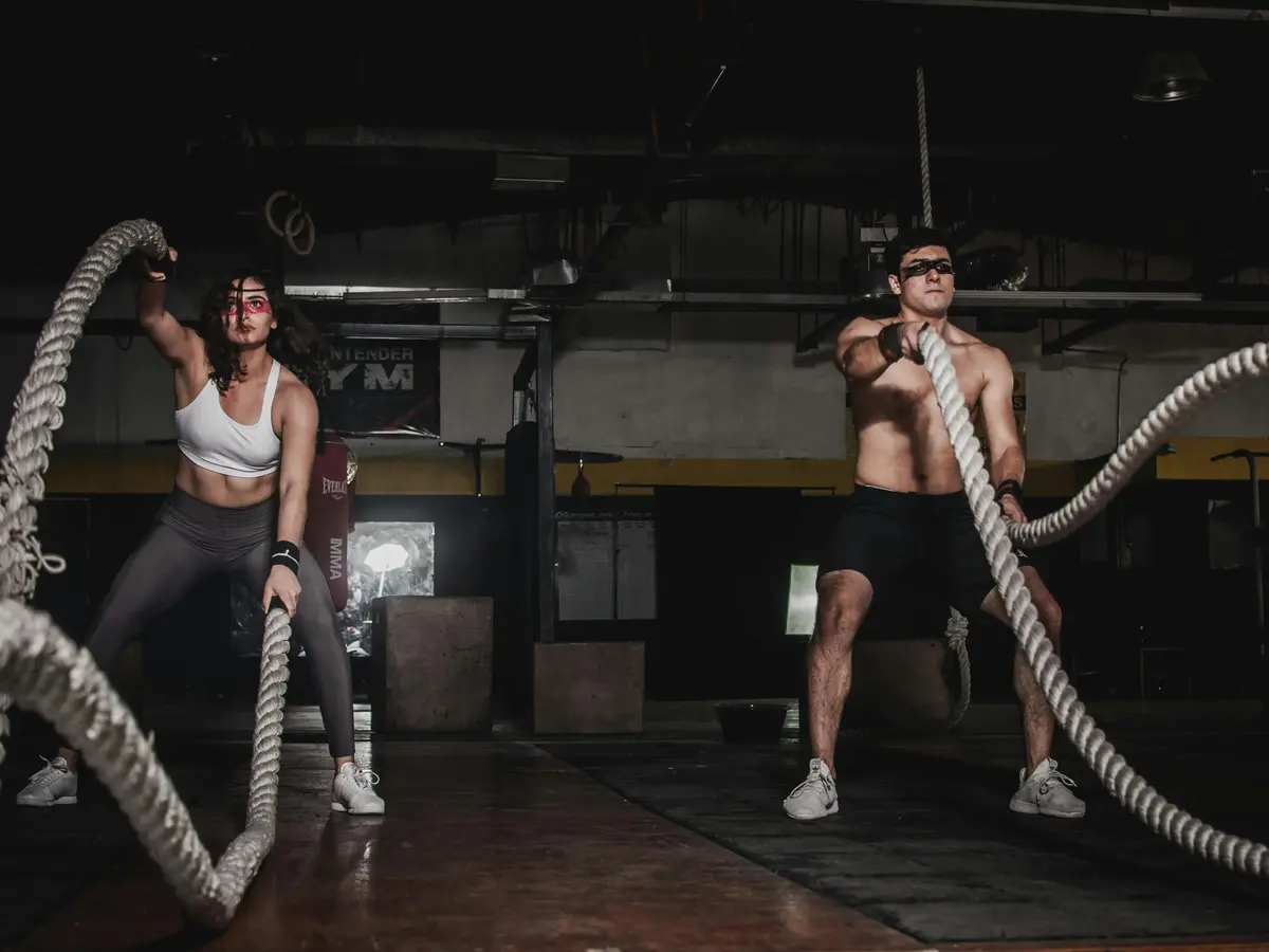 two people using battle ropes