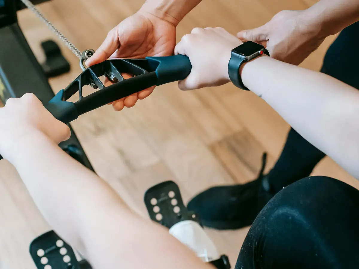 person pulling the rope from rowing machine