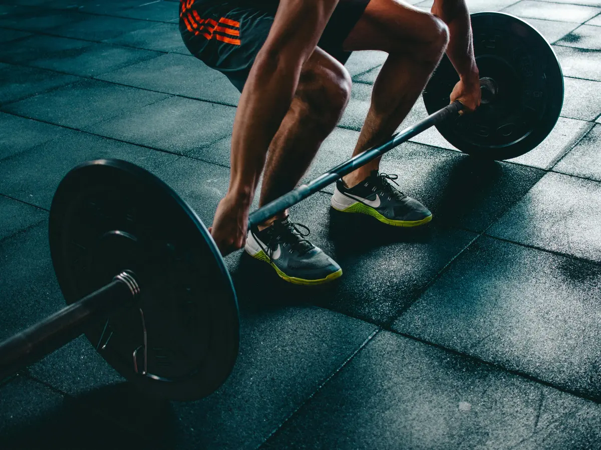 person lifting a bar with weights